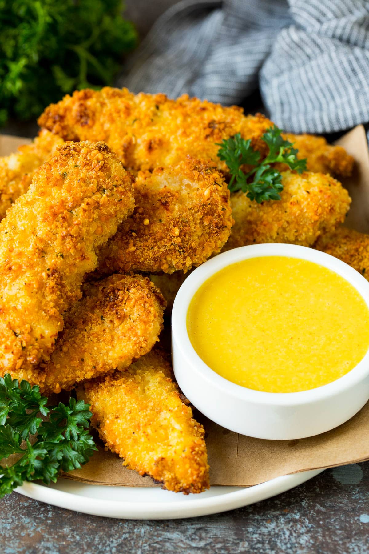 This honey mustard sauce is the perfect blend of sweet, creamy and tangy and takes just 5 minutes to make. A bowl of honey mustard sauce served with chicken fingers.