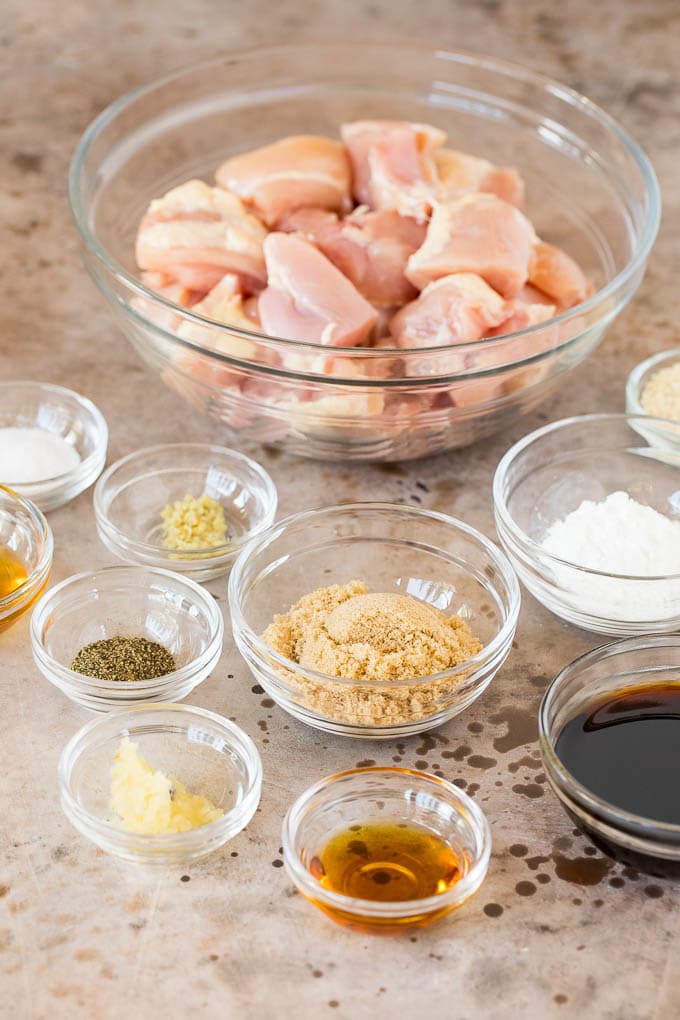 This Instant Pot teriyaki chicken is chicken thighs pressured cooked in a homemade sweet and savory teriyaki sauce. Bowls of ingredients including chicken, soy sauce, brown sugar and garlic.