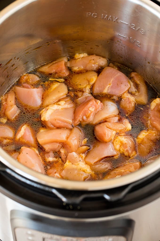 This Instant Pot teriyaki chicken is chicken thighs pressured cooked in a homemade sweet and savory teriyaki sauce. Chicken and sauce in a pressure cooker.