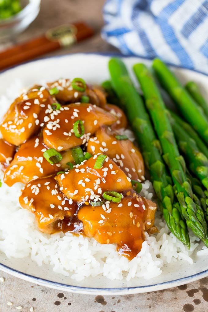 This Instant Pot teriyaki chicken is chicken thighs pressured cooked in a homemade sweet and savory teriyaki sauce. A plate of Instant Pot teriyaki chicken on rice.