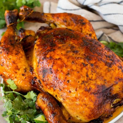 Peruvian chicken served with sauce and garnished with cilantro.