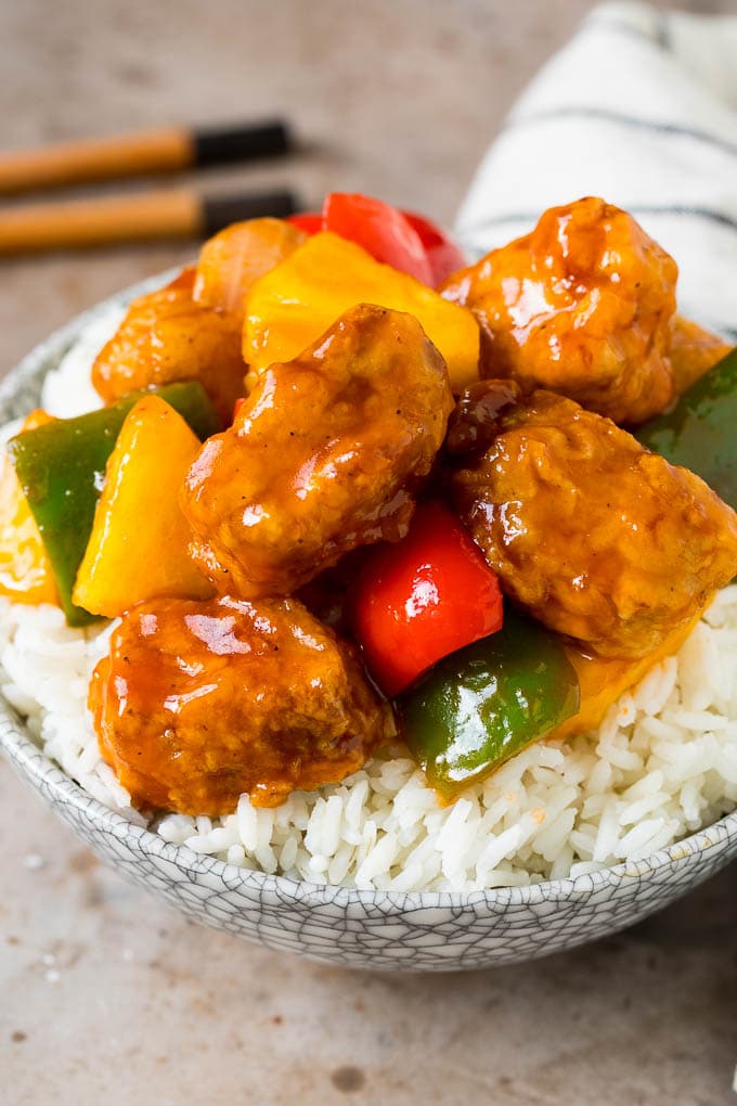 This sweet and sour pork is chunks of pork tenderloin that are breaded and fried, then tossed with pineapple and fresh vegetables in a homemade sauce. Sweet and sour pork served over rice.