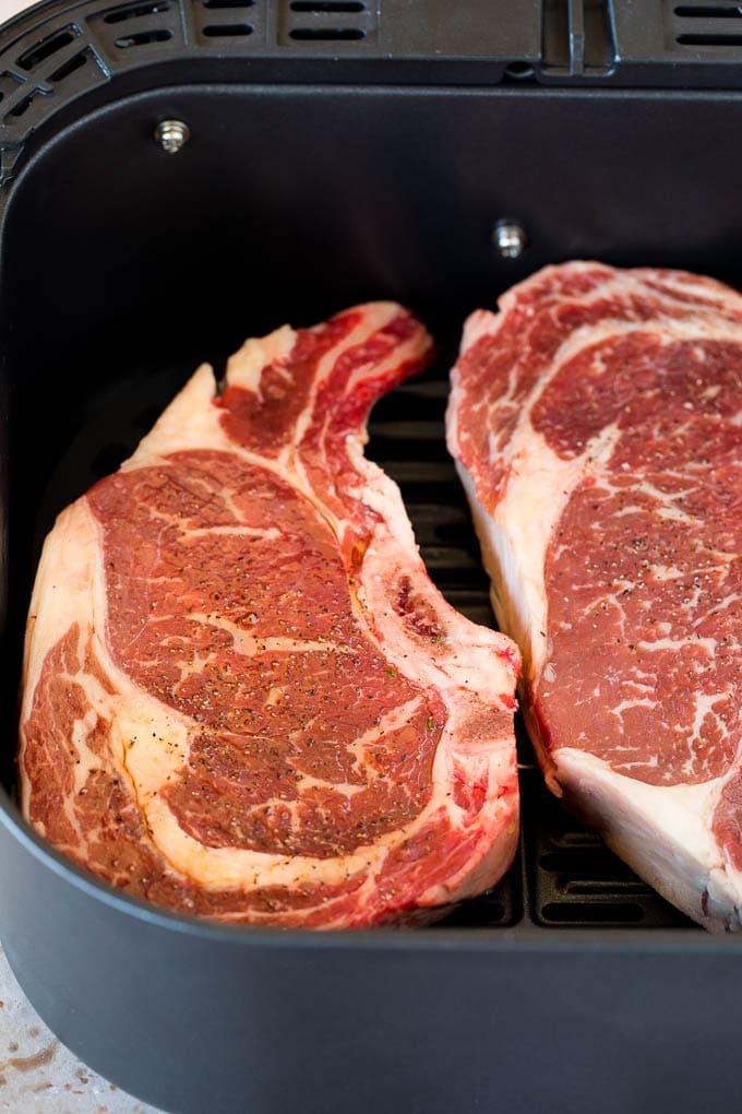 Rib eye steaks in an air fryer.