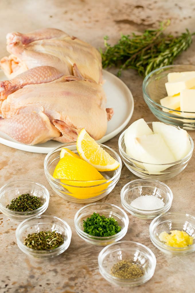 This roasted Cornish hen recipe is an easy and elegant way to make a meal that's quick enough for a busy weeknight, yet fancy enough for a special occasion. Bowls of ingredients including butter, herbs and lemon.