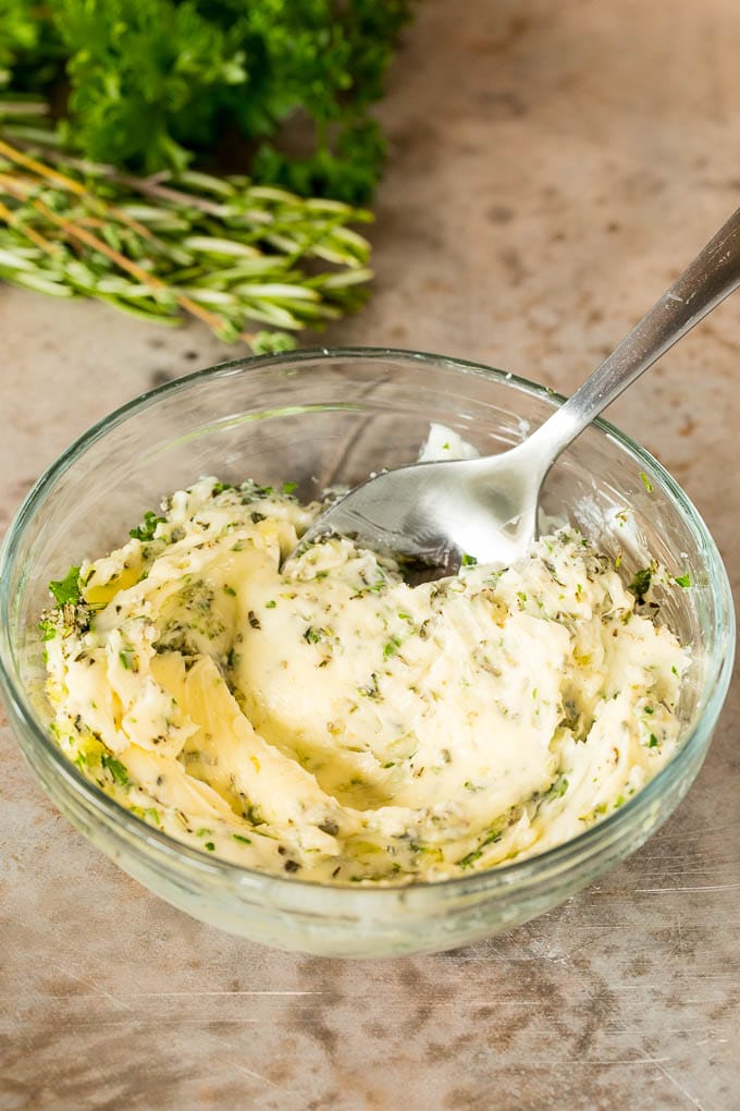 This roasted Cornish hen recipe is an easy and elegant way to make a meal that's quick enough for a busy weeknight, yet fancy enough for a special occasion. A bowl of butter mixed with garlic and herbs.