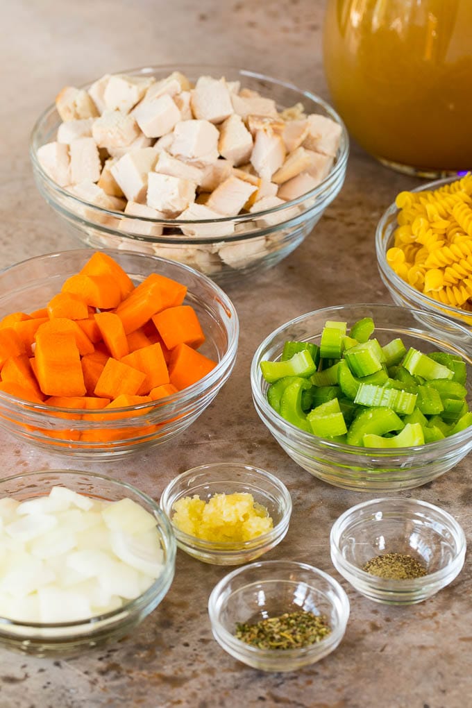 This turkey noodle soup is chunks of turkey, vegetables and pasta, all simmered together in a homemade broth. Bowls of vegetables, diced turkey and pasta.