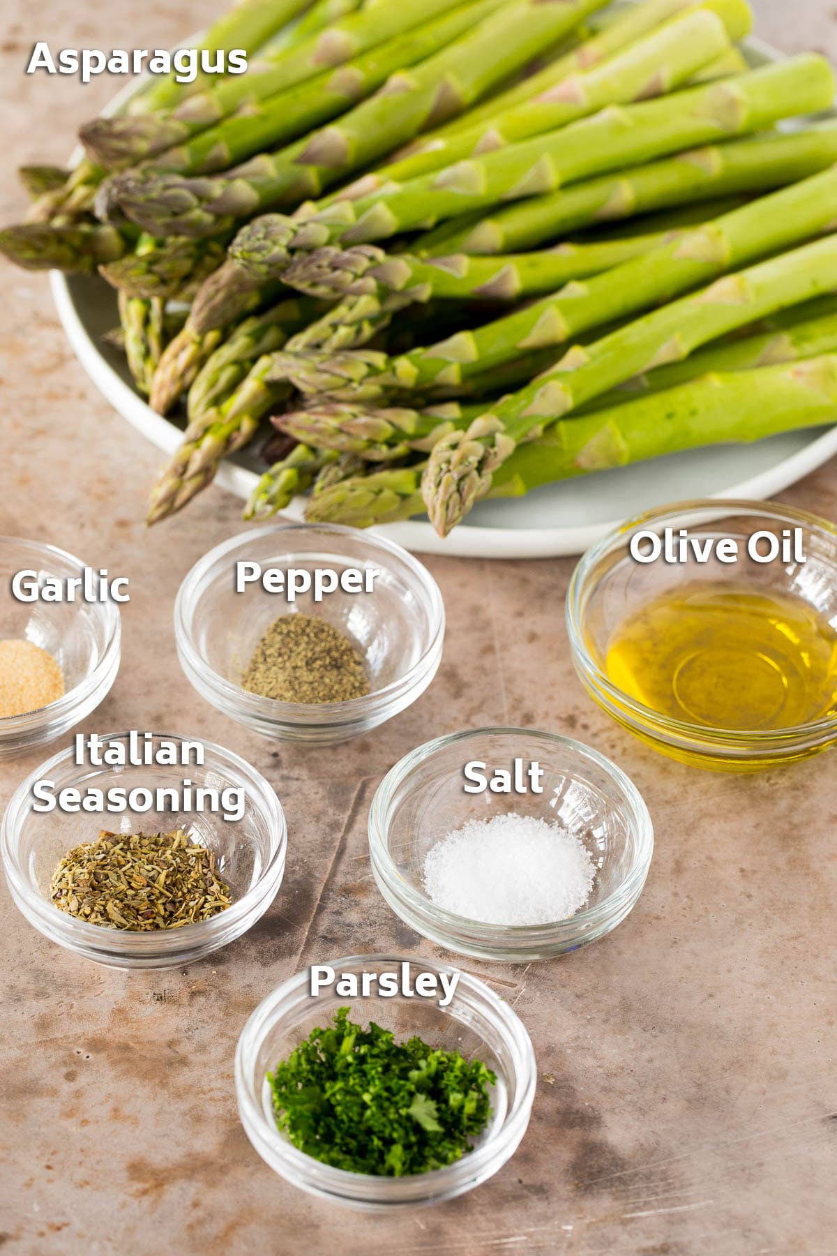 Ingredients including asparagus, olive oil and seasonings.