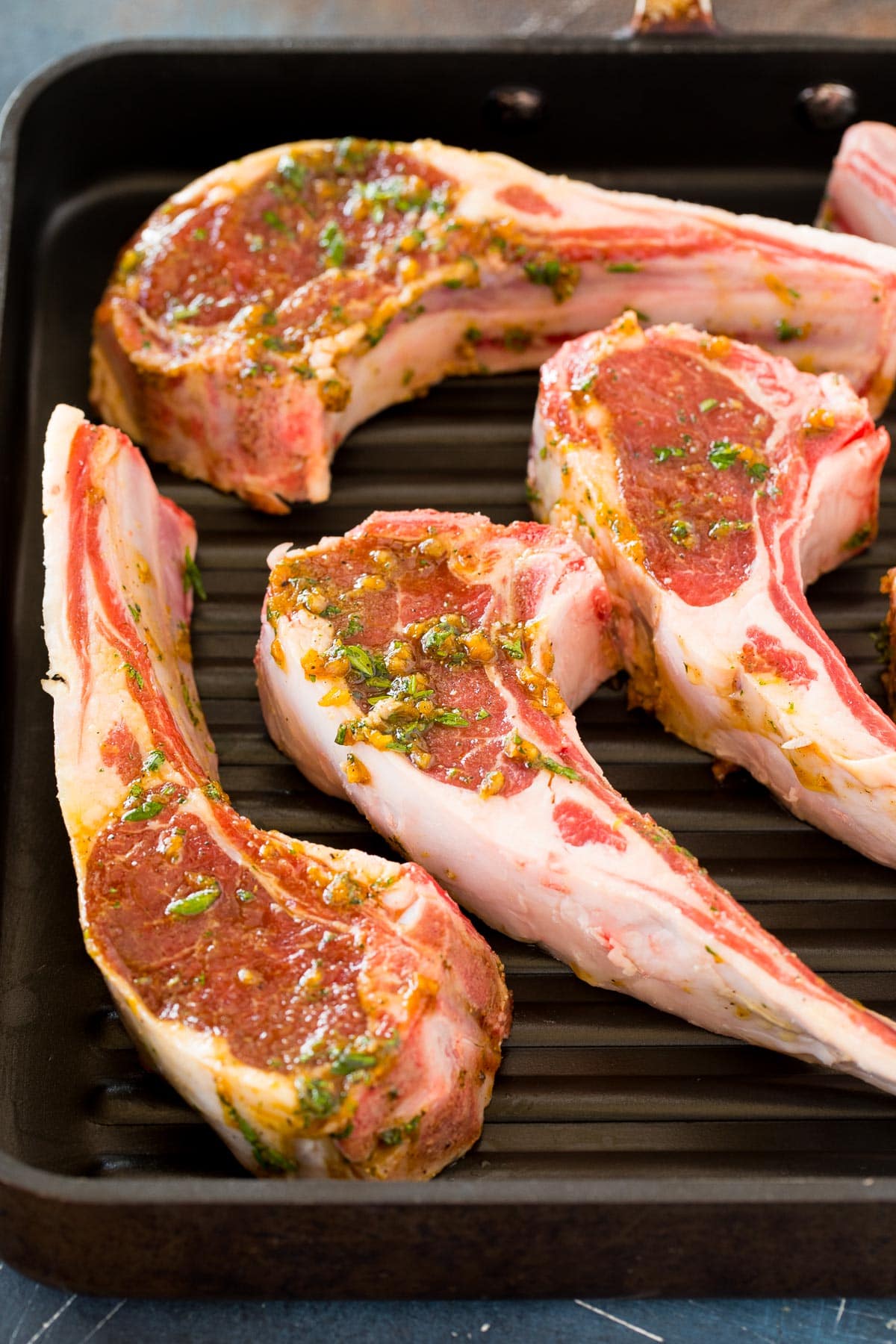 Meat in marinade on a grill pan.