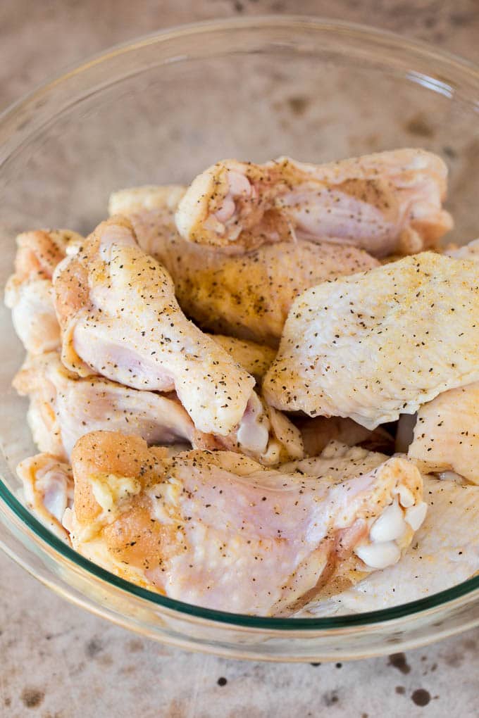 These air fryer chicken wings come out perfectly crispy every time, and cook so much faster than they would in a traditional oven. Chicken wings seasoned with garlic, salt and pepper.