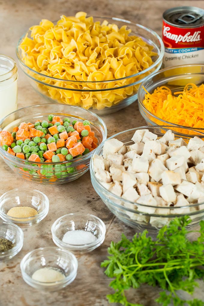 This turkey casserole is made with diced leftover turkey, egg noodles and vegetables, all tossed in a creamy cheesy sauce. Bowls of poultry meat, vegetables, noodles and seasonings.