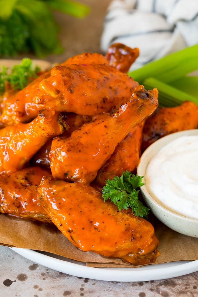 These air fryer chicken wings come out perfectly crispy every time, and cook so much faster than they would in a traditional oven. Air fryer chicken wings coated in buffalo sauce and served with ranch and celery.