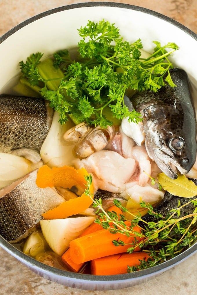 This bouillabaisse is French seafood stew with fresh fish, shrimp, clams and mussels, all simmered together in a flavorful broth. A pot of fish trimmings and vegetables for stock.