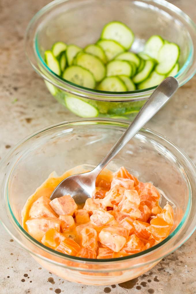 This sushi bowl recipe is assorted fresh fish, avocado, cucumber and seaweed, all served over rice with spicy mayo, picked ginger and tobiko. Bowls of marinated cucumbers and salmon in spicy mayo.