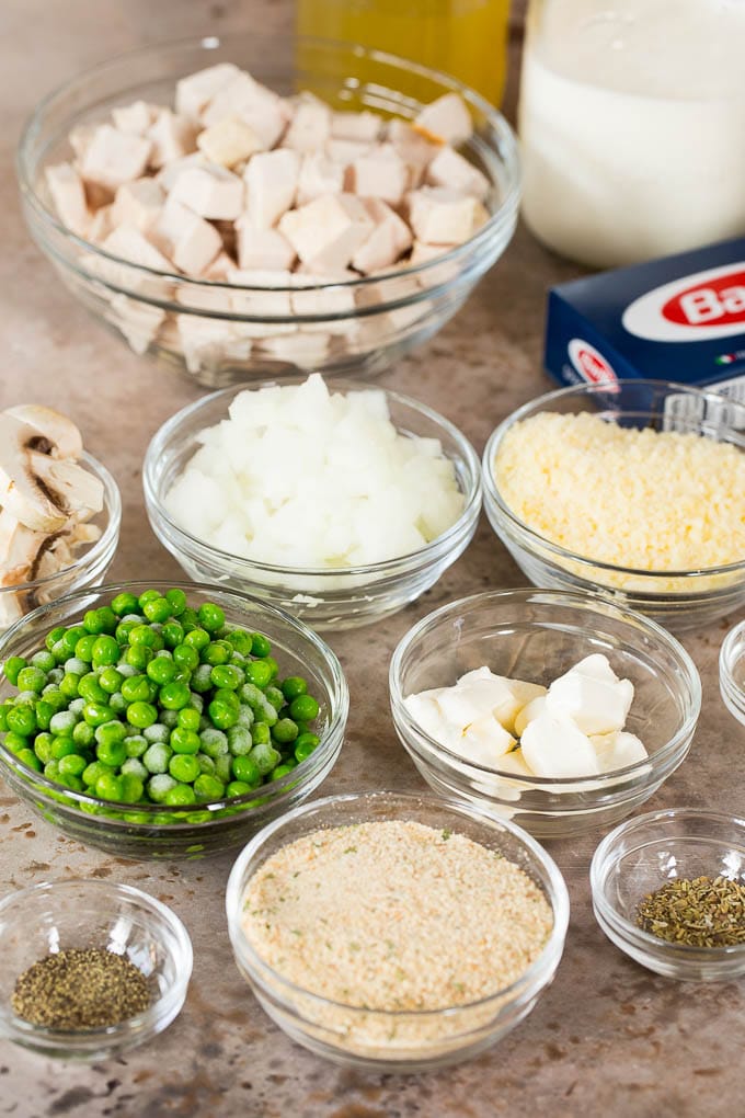 This turkey tetrazzini contains diced turkey, mushrooms and peas, all tossed with pasta in a creamy sauce, then baked to perfection. Bowls of diced meat, vegetables, seasonings and breadcrumbs.