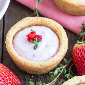 A picture of a cookie cup with a strawberry cheesecake filling.