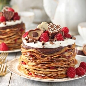 An image of a chocolate raspberry mini crepe cake on a plate.
