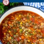 An image of alphabet soup made of ground beef, vegetables and tender pasta, all simmered in a hearty tomato broth.
