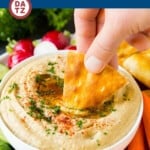A bowl of baba ganoush which is a creamy dip made of eggplant, tahini, olive oil, lemon juice and spices.