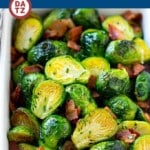 A baking pan of bacon roasted brussels sprouts which are crispy on the outside, soft on the inside and full of smoky flavor.