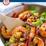 This pan of kung pao shrimp is chock full of veggies and peanuts and is cooked in a savory yet spicy sauce.