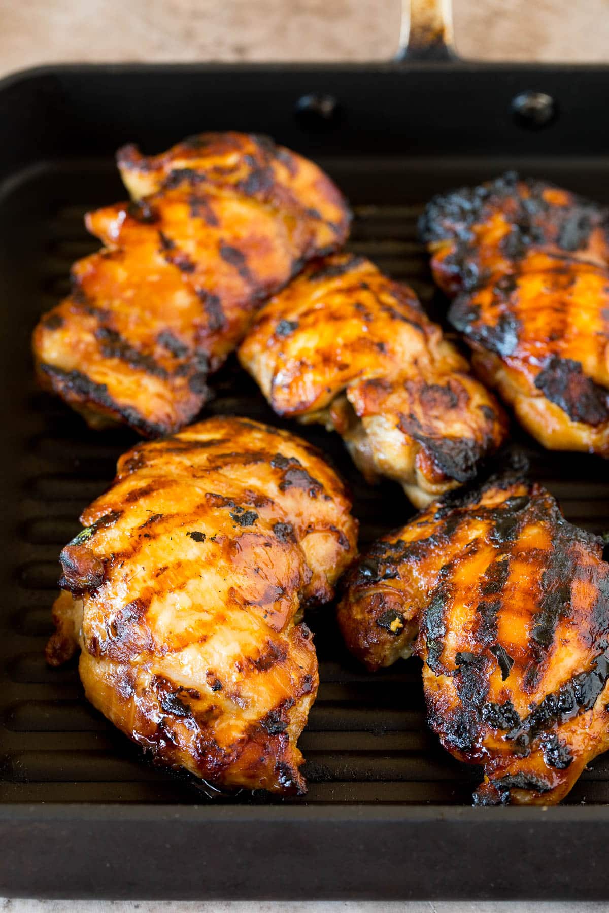 Teriyaki chicken on a grill pan.