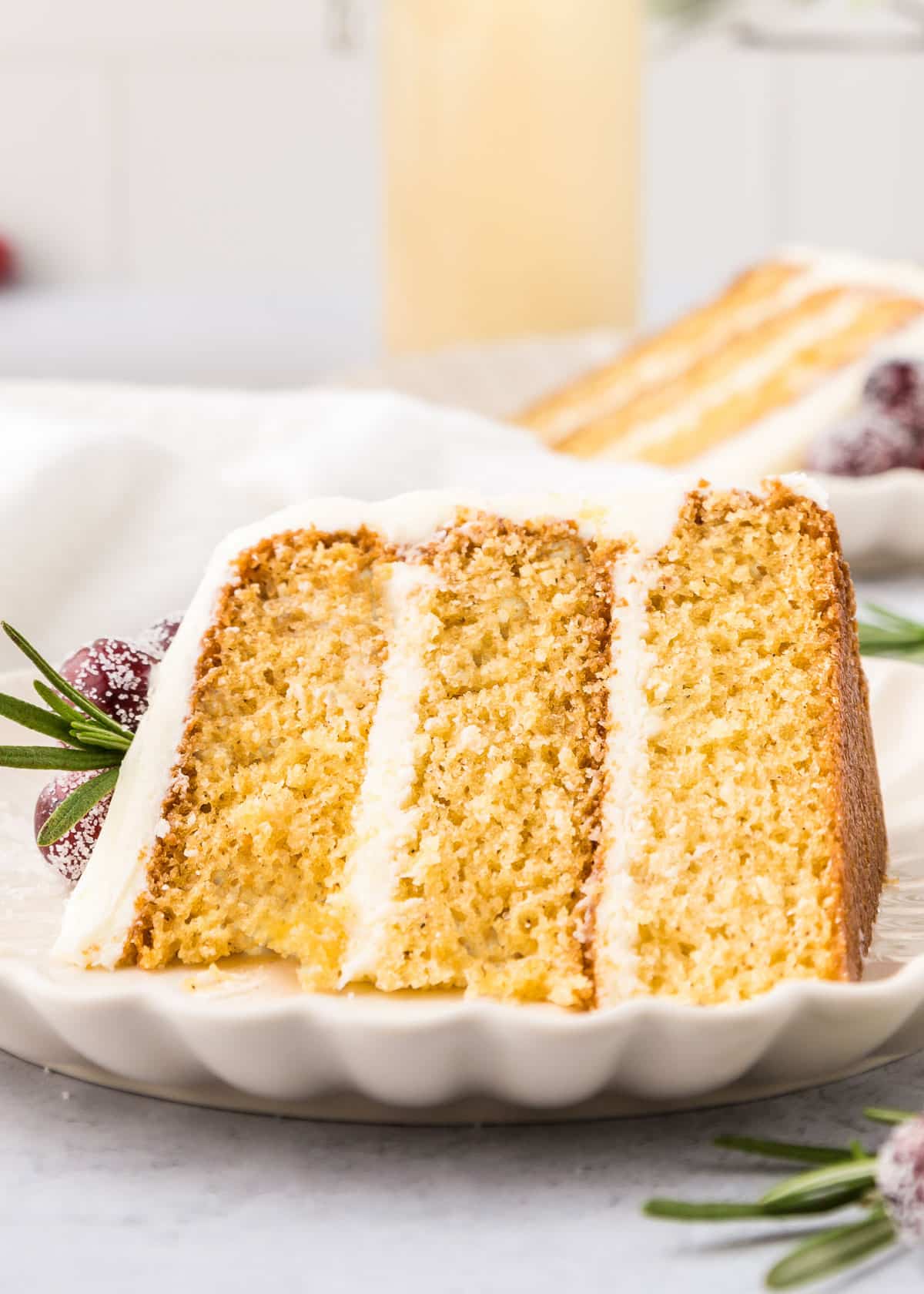 A slice of eggnog cake on a serving plate.