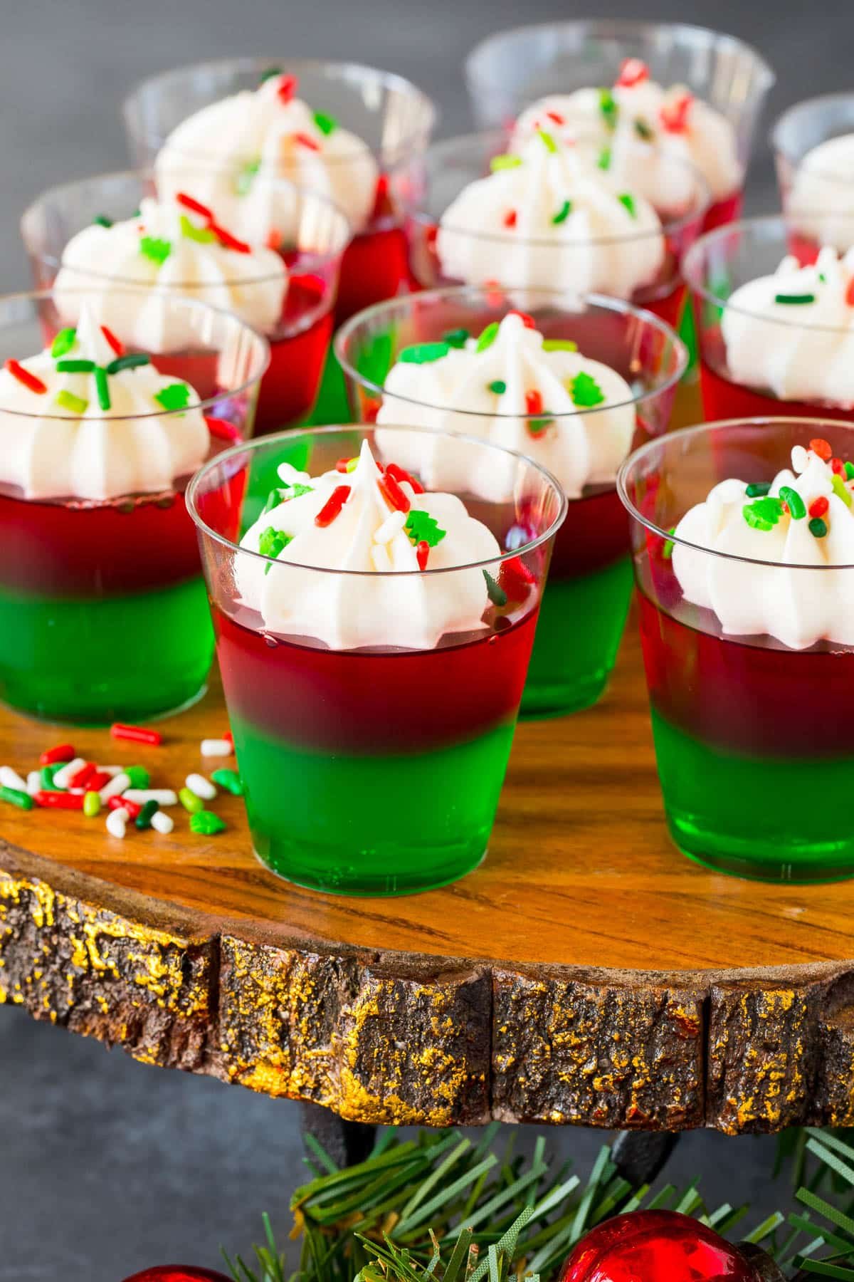 A tray of Christmas Jello shots decorated with sprinkles.