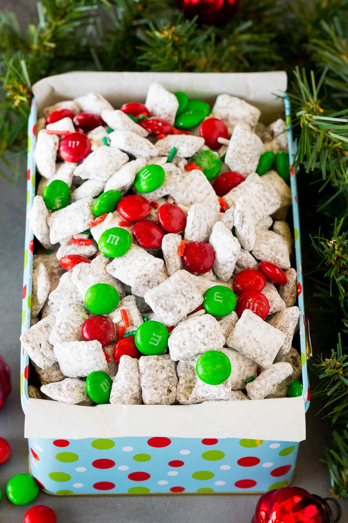 A holiday tin filled with Christmas puppy chow mix.