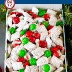 This Christmas puppy chow is Chex cereal mixed with peanut butter, chocolate and sprinkles, then coated in powdered sugar and tossed with red and green M&M's.