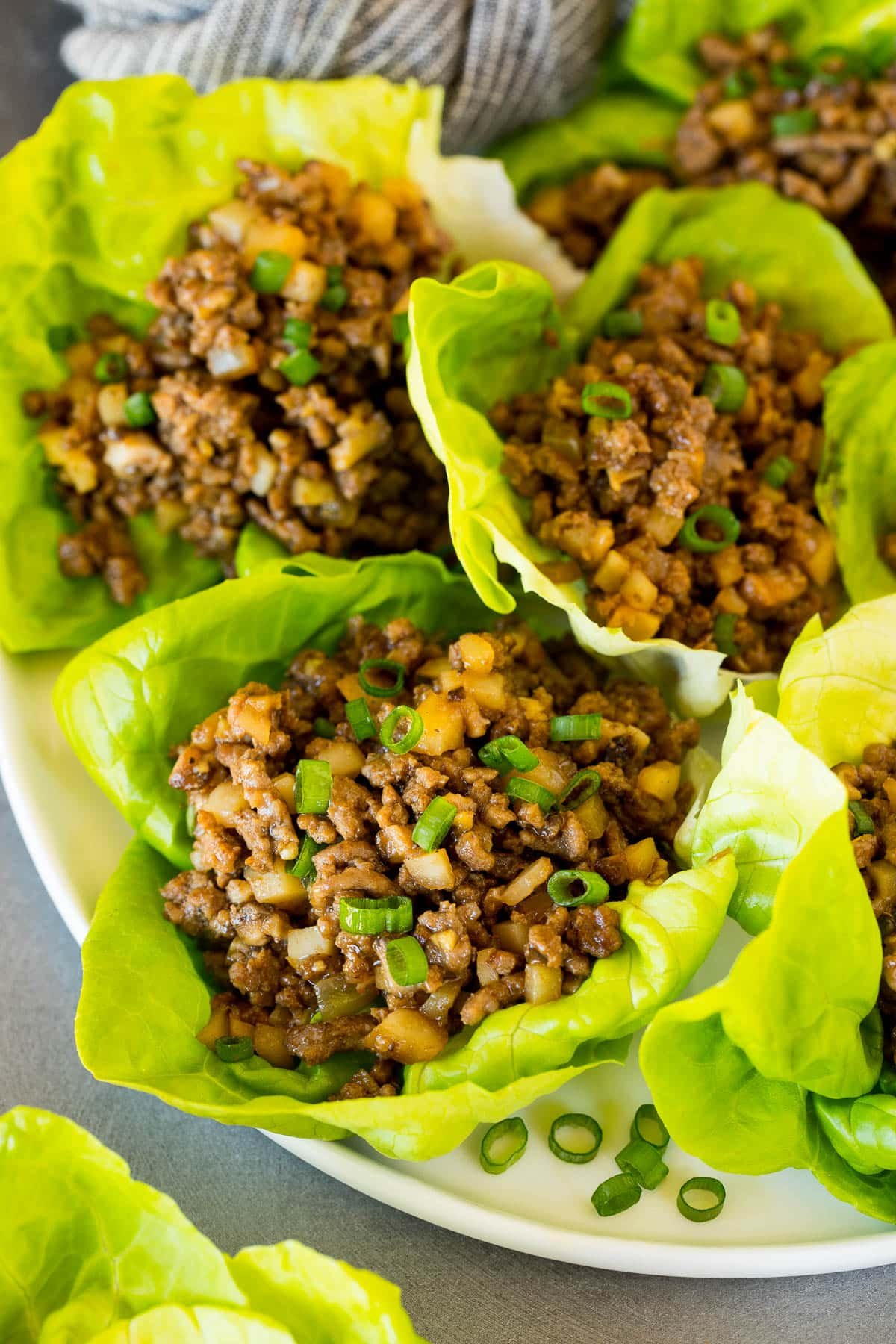 Ground beef lettuce wraps on a white serving plate.