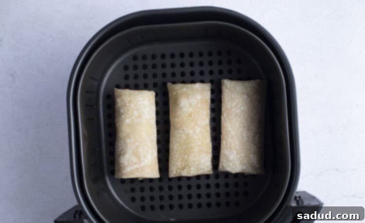 Frozen burritos ready to be placed in the air fryer basket