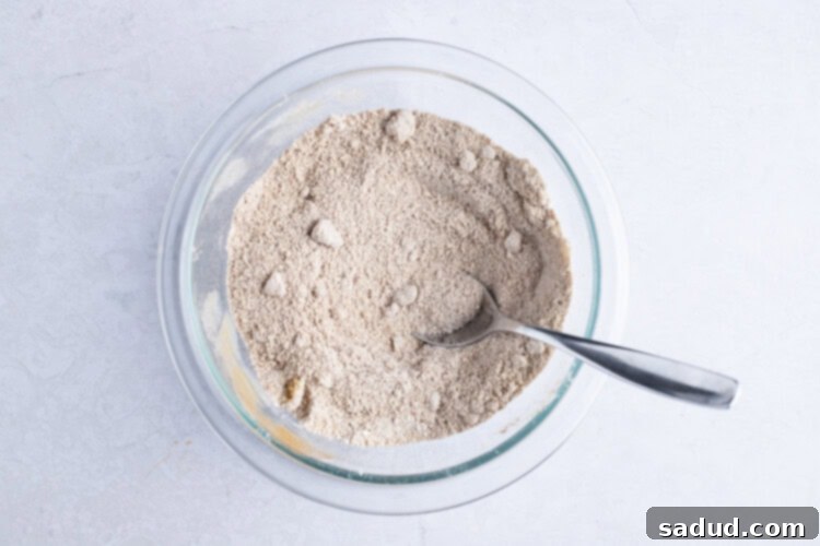 Cinnamon-sugar filling mixture in glass bowl with spoon
