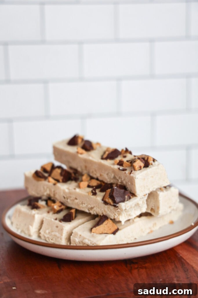 Stack of high-protein Frozen yogurt bars with peanut butter and chocolate cups on a white plate.