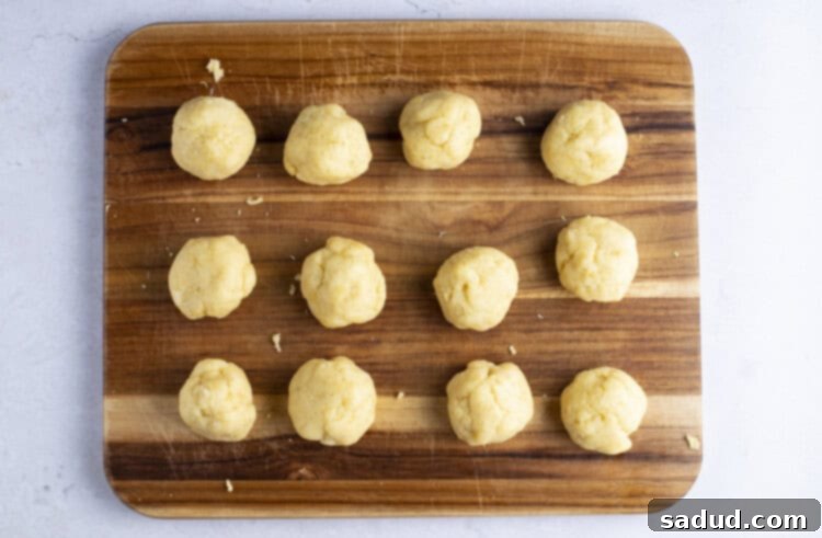 Keto empanada dough balls on a wooden cutting board