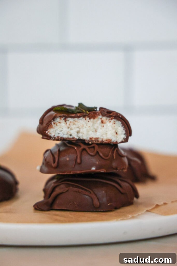A stack of Homemade healthy vegan peppermint patties, showcasing their chocolate coating and white peppermint filling.