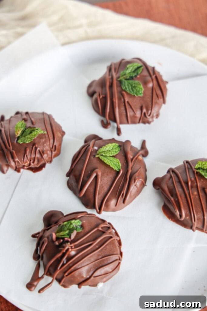 Homemade vegan peppermint patties on a parchment-lined tray, ready for coating.