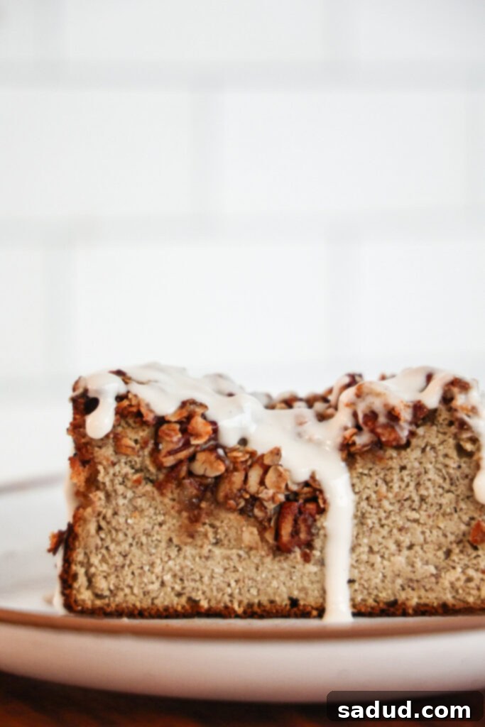 A slice of healthy protein banana bread with a dusting of powdered sugar.
