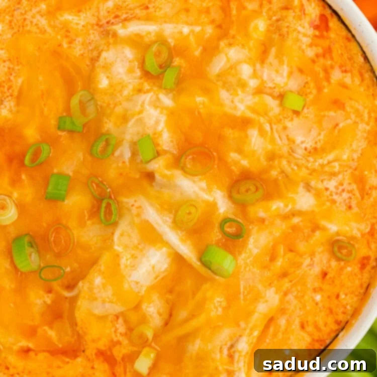overhead closeup image of instant pot buffalo chicken dip with sliced green onions on top