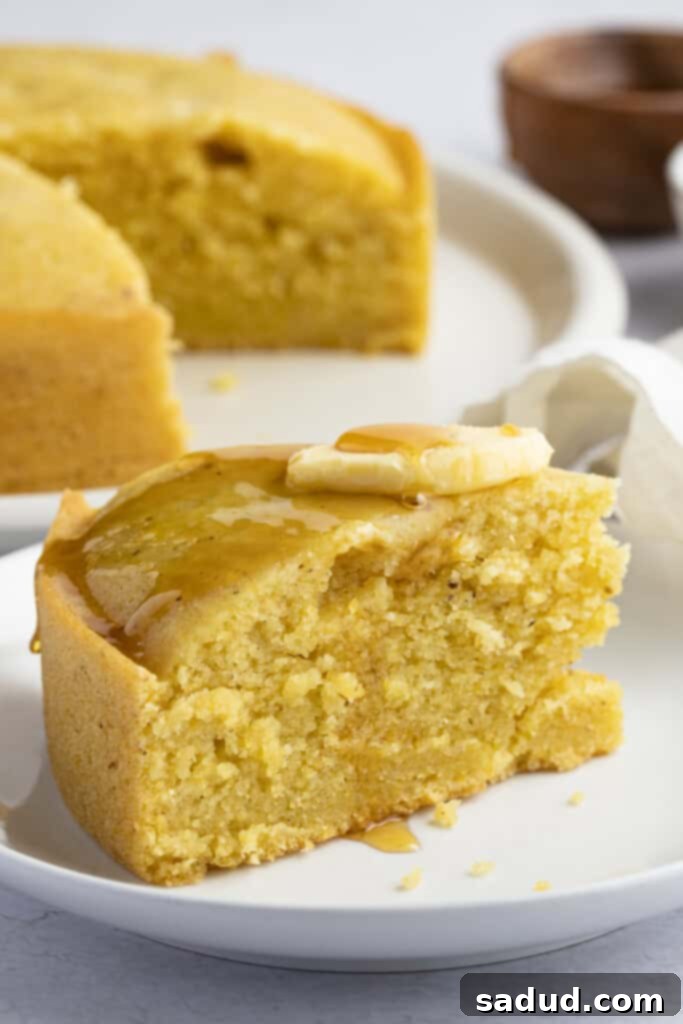 Freshly sliced Instant Pot cornbread, golden brown and moist, presented on a rustic surface