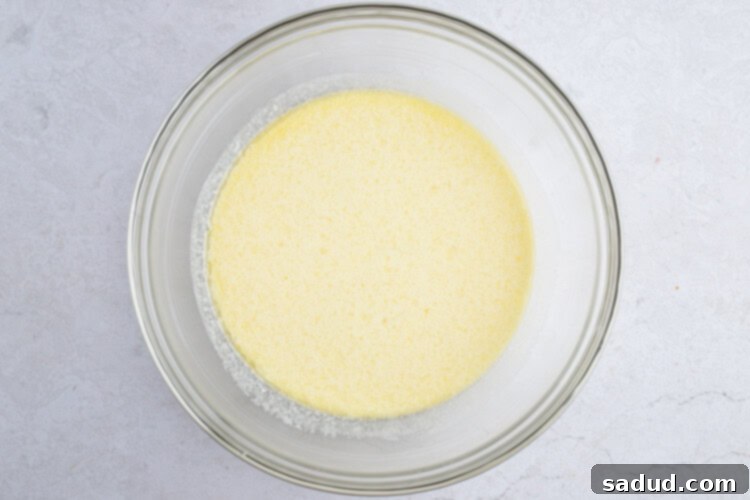 Wet ingredients for Instant Pot cornbread in a large glass bowl