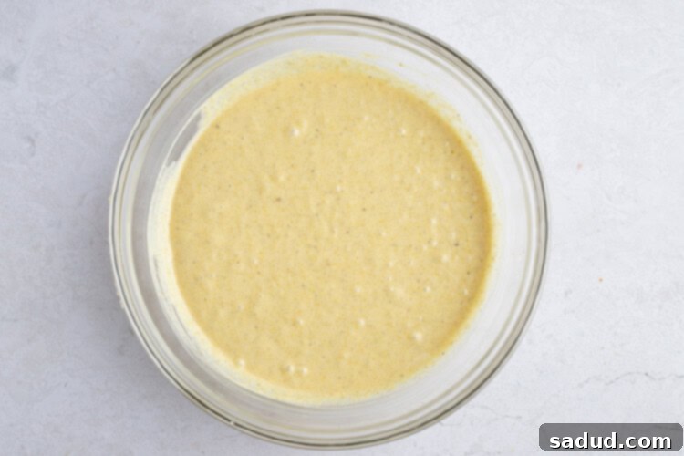 Instant Pot cornbread batter in a large glass mixing bowl