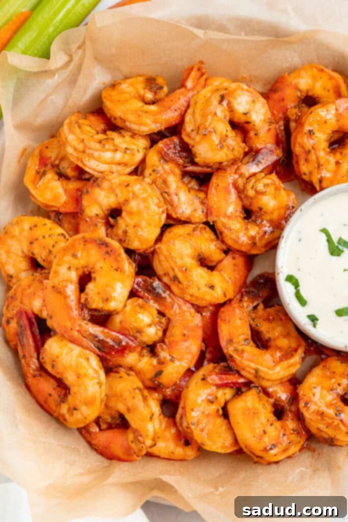 buffalo shrimp on a plate with ranch dressing on the side
