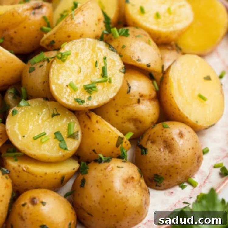 sous vide potatoes on a plate with fresh parsley on the side