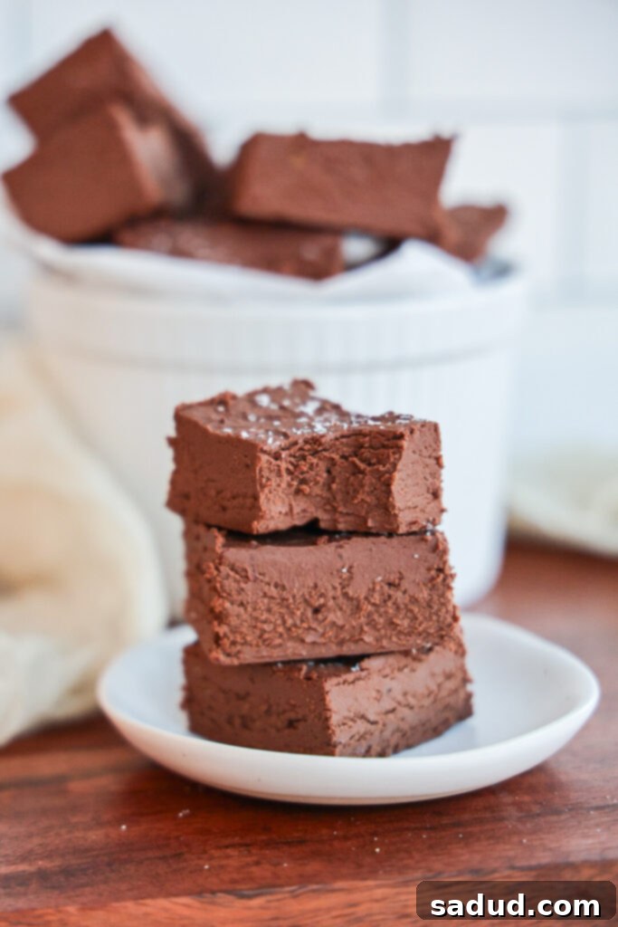 Close-up of healthy two-ingredient fudge cut into squares in a loaf pan, showing its creamy texture.