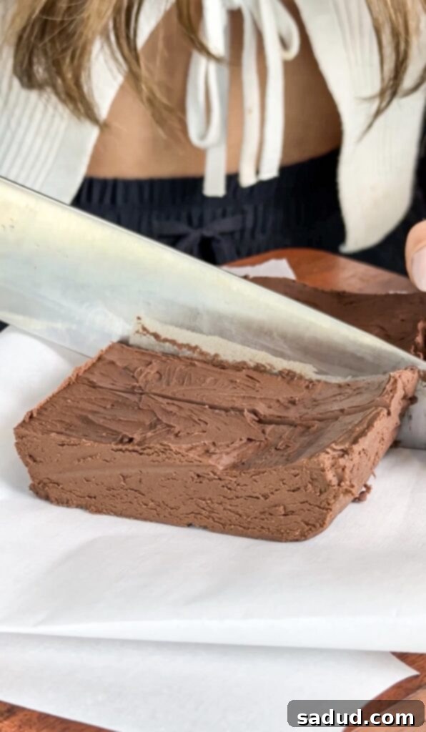 Step 3: Pouring mixed healthy fudge batter into a parchment-lined pan.