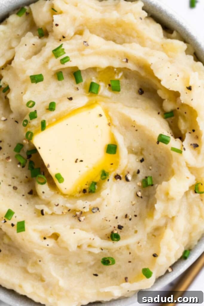 overhead image of sous vide mashed potatoes in a bowl with butter and chives