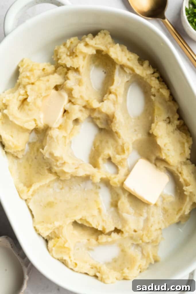 The Best Three Ways to Reheat Mashed Potatoes 4 mashed potatoes in a baking dish with milk and butter