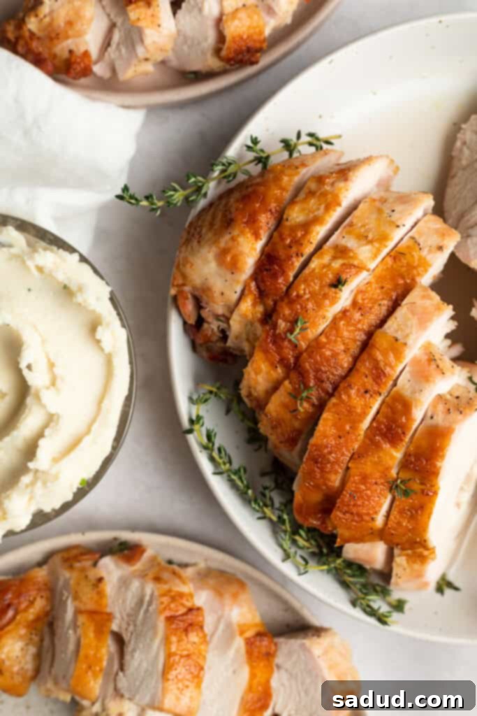 overhead image of turkey breast sliced and served on three separate plates with serving utensils