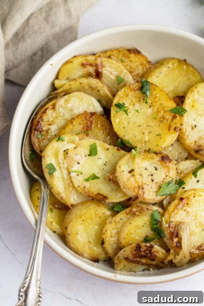 Smothered potatoes in a bowl positioned toward the right side of the image so you only see half the bowl