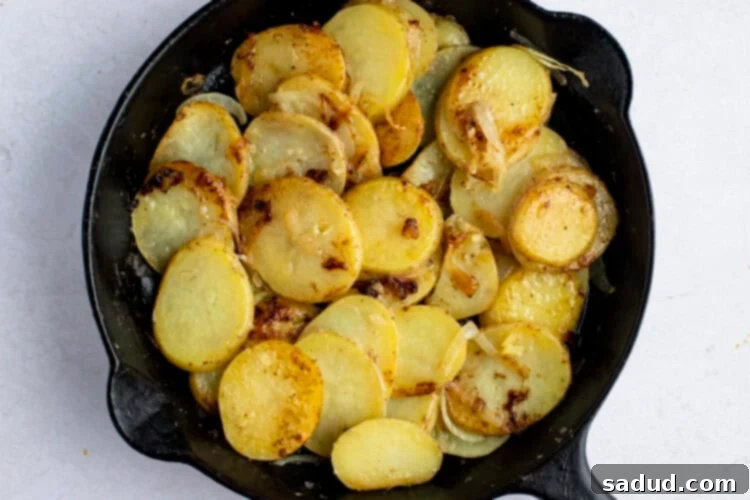 Smothered potatoes in cast iron skillet
